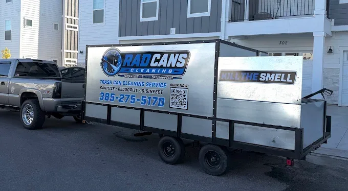Rad Cans Cleaning trash can cleaning trailer with Kill the Smell wrap parked outside a Utah townhome