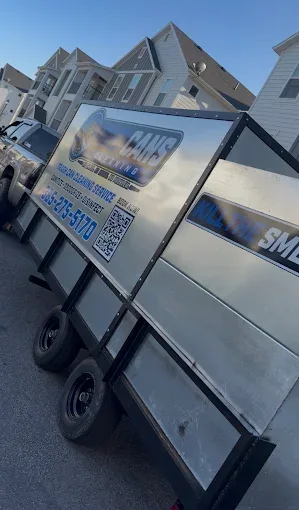 Rad Cans trash can cleaning trailer arriving in a Utah neighborhood on pickup day